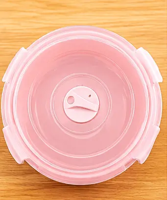 top view looking inside an open pink food container with inner rim detail top view looking inside an open pink food container with inner rim detail