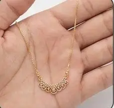 gold filigree crystal arch crescent necklace on hand