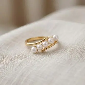 gold plated 5 pearl curved open bypass ring lifestyle shot gold plated 5 pearl curved open bypass ring lifestyle shot
