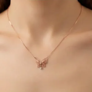 Rose Gold Filigree Butterfly Pendant Necklace with Small Crystal Drop on Woman Neck