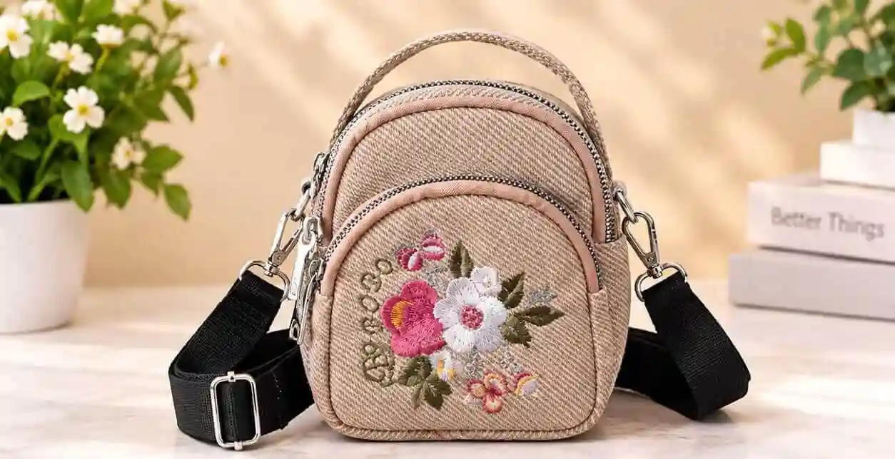 Beige Floral Embroidered Mini Crossbody Bag Stylish beige textured mini crossbody bag and backpack with floral embroidery and strap at Sabuj Hub