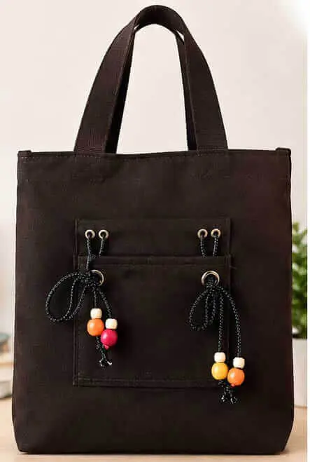 Black Canvas Tote Handbag with Wooden Beads Sabuj Hub Sabuj Hub stylish black canvas tote bag featuring front pocket and colorful wooden beads decoration