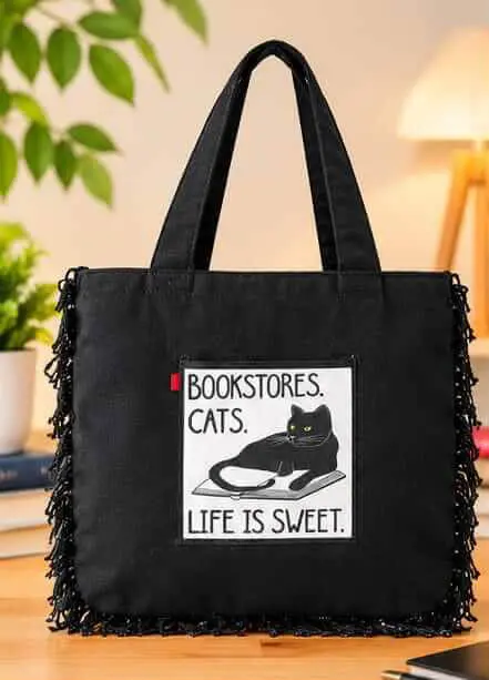 Black Tote Bag Bookstore Cats Print Sabuj Hub Sabuj Hub black canvas tote bag featuring Bookstore Cats Life is Sweet graphic patch and fringe trim details