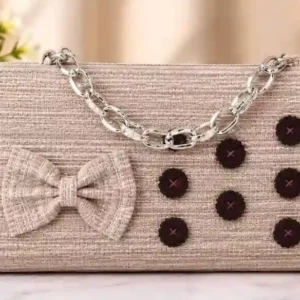 Light brown clutch and sling bag with bow detail, dark buttons, and metallic chain handle at Sabuj Hub