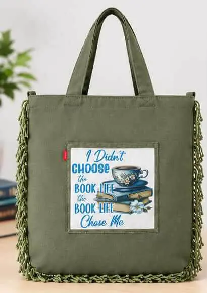 Olive Green Book Life Tote Bag Front View Sabuj Hub Front view of Sabuj Hub olive green canvas tote bag featuring book life quote print and side fringes detail