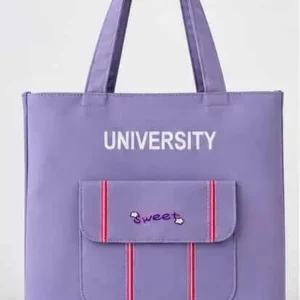 Front view of Sabuj Hub purple canvas tote bag featuring UNIVERSITY text print and sweet pocket detail