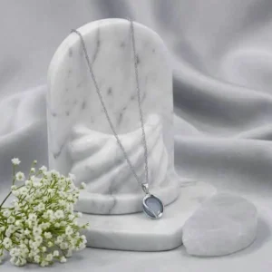 Silver Oval Opal Moonstone Pendant Necklace Displayed on Marble Stand